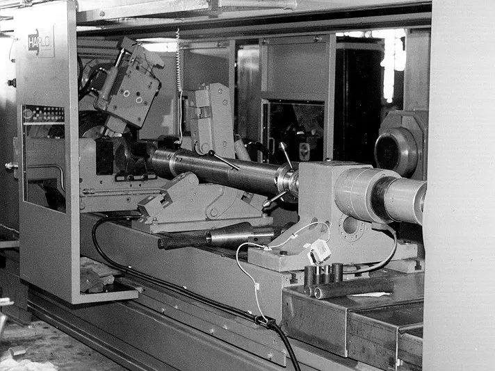 The DHL-500 friction welding machine with a long workpiece clamped, archive photo