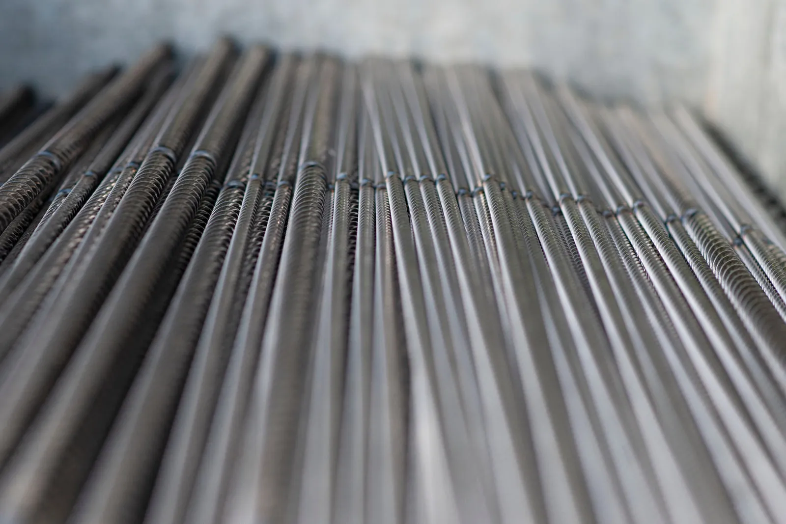 Welded shanks lined up in a crate, the twisted and plain sections meeting at the joint